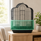 Green mesh bird cage seed catcher fitted to a bird cage in a home setting to help contain scattered seed husks and cage mess.