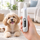 White cordless dog paw trimmer with LED light held during at-home grooming