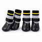 Angled view of four waterproof dog socks with adjustable straps on a white background